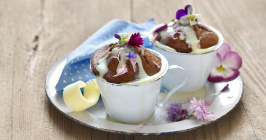 Fluffy cocoa poppy muffins with white chocolate sauce