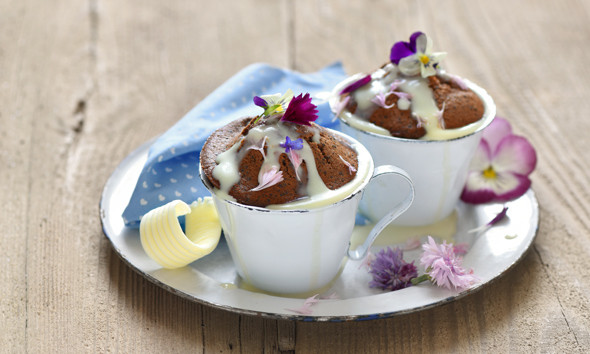 Fluffy cocoa poppy muffins with white chocolate sauce